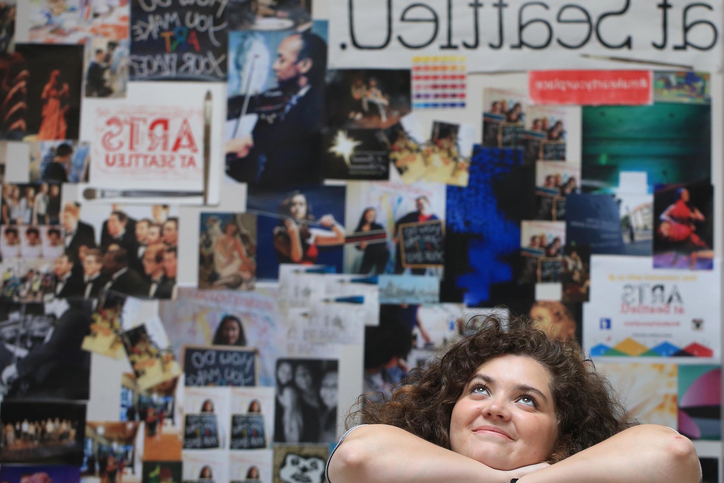 Meme Garcia, '15, Fulbright scholar, and double major in theatre and women & gender studies, posed in front of an Arts at Seattle U collage.